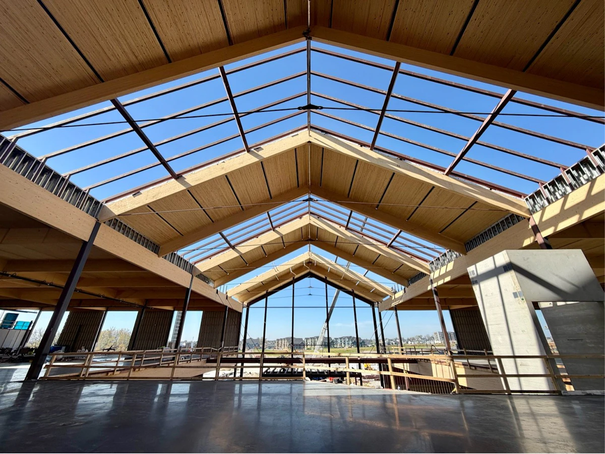 Glulam and steel-rod trusses beneath the gabled roof of the Homemakers atrium