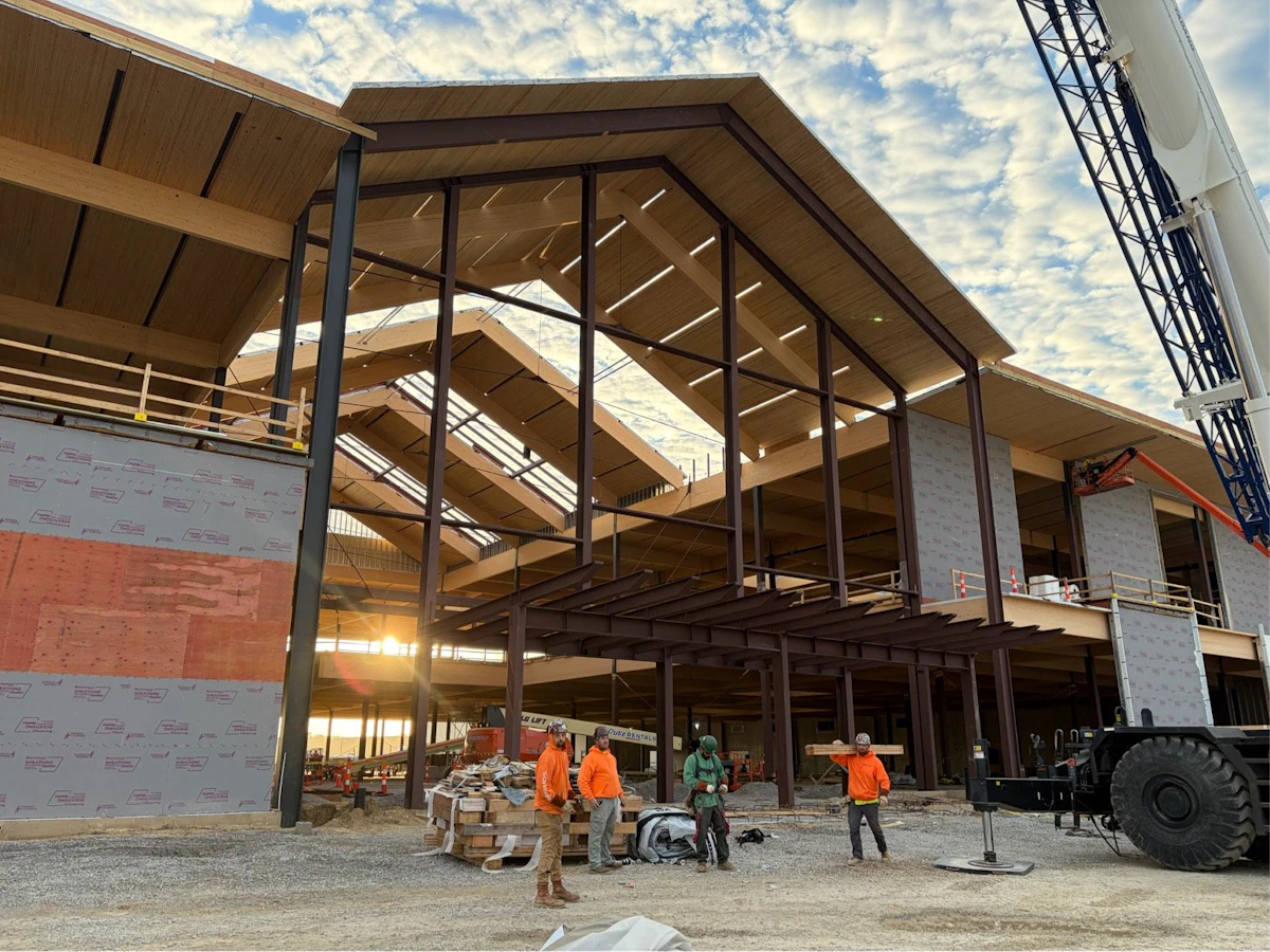 Site crew and crane beside the Homemakers entrance framing