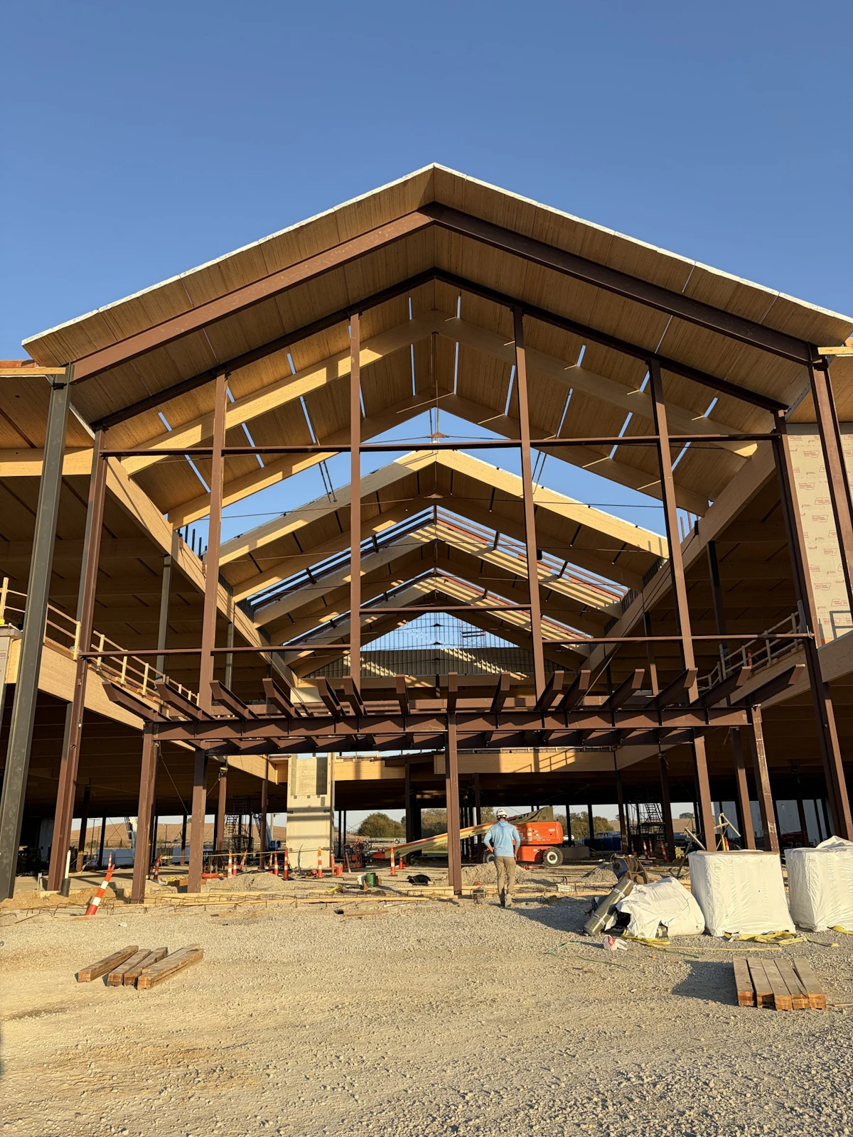 Full-height view through the timber and steel framing of the Homemakers entrance