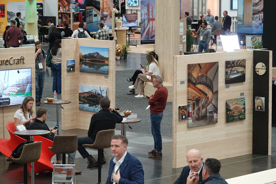 Visitors gather around the Willow House CLT pavilion at the 2025 International Mass Timber Conference.