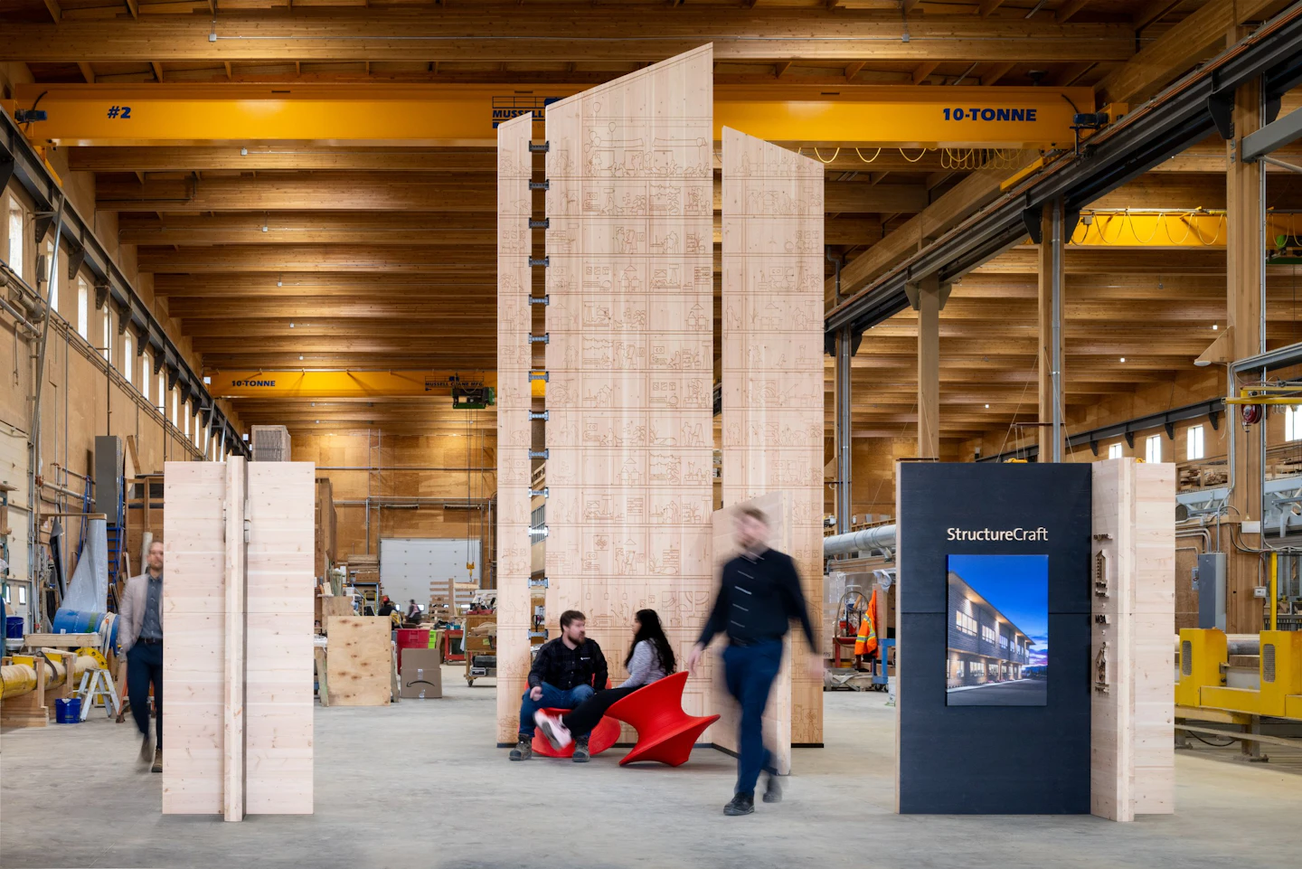 Willow House pavilion assembled in StructureCraft’s shop, with CNC-carved CLT walls and people for scale.