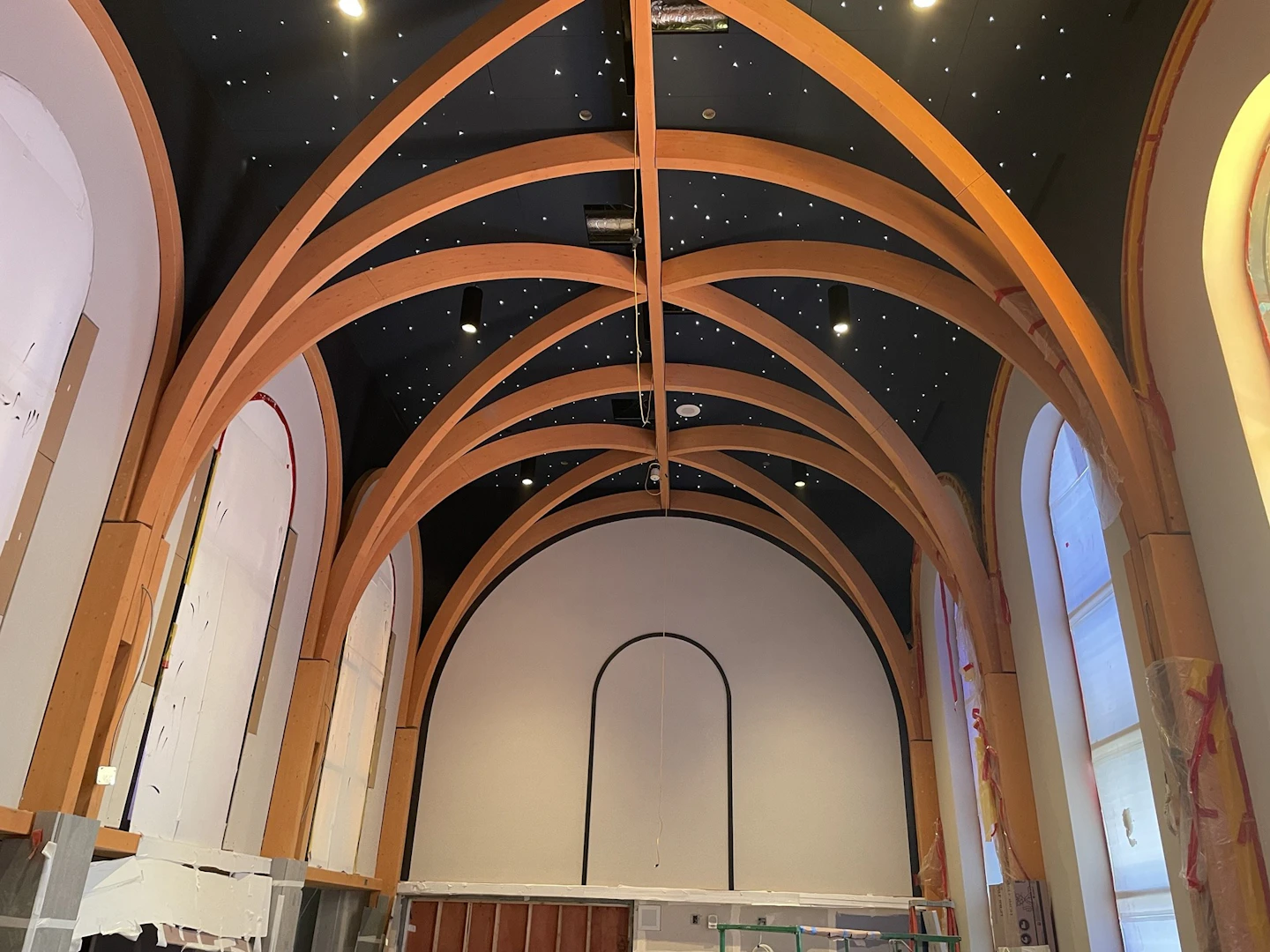 Completed curved timber arches beneath the star-lit ceiling of New St. Paul’s Hospital Chapel