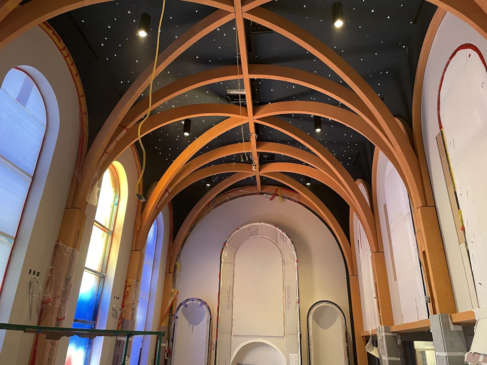View along the completed chapel beneath the curved timber arches