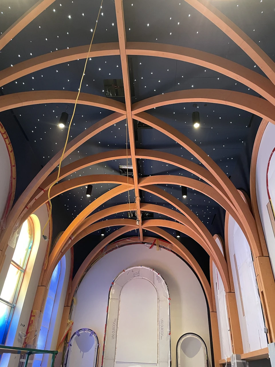 Upward view of the chapel’s repeated timber arches