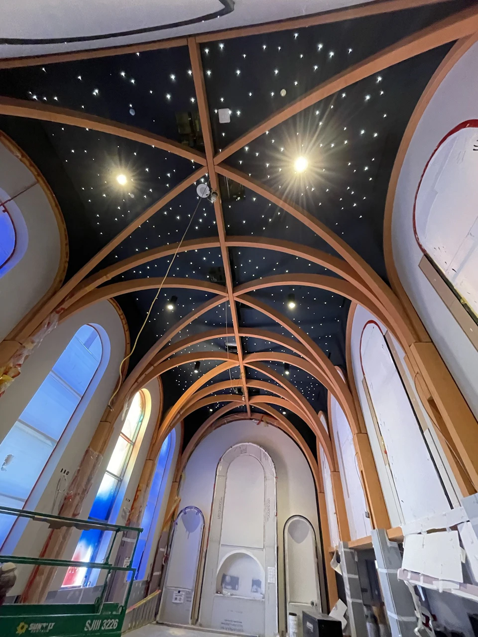 Full-height view of the timber arches and illuminated chapel ceiling