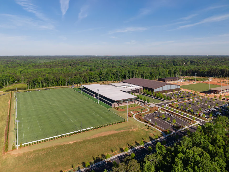 Aerial view of the U.S. Soccer National Training Center campus with the timber canopy beside the fields.