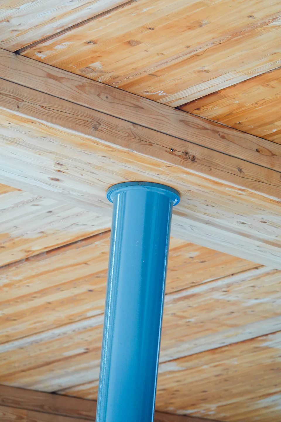 Timber ceiling around a blue column at Abbotsford Christian School Entrance