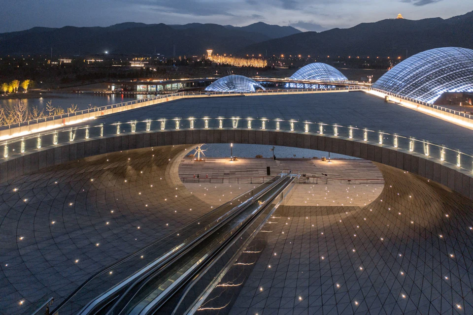 Illuminated bridge and plaza at Taiyuan Botanical Garden domes