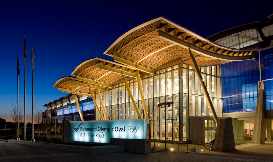 Illuminated entrance beneath the wood roof at Richmond Olympic Oval