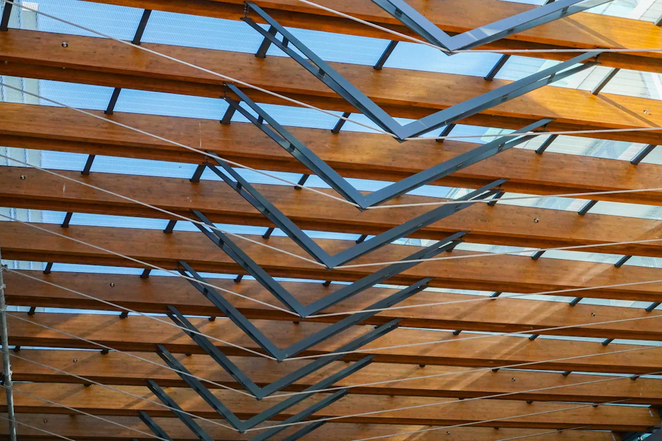 Wood-and-steel lattice beneath the Ambleside Galleria canopy