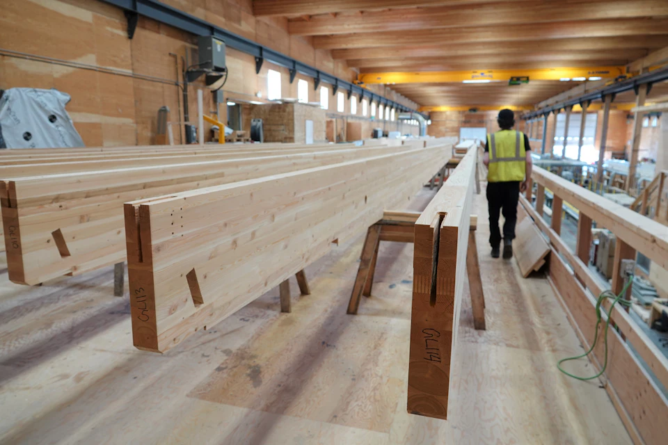 Long wood beams in the fabrication shop for Ambleside Galleria