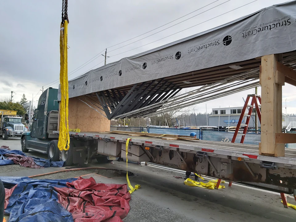 Crane lifting a roof assembly for Ambleside Galleria