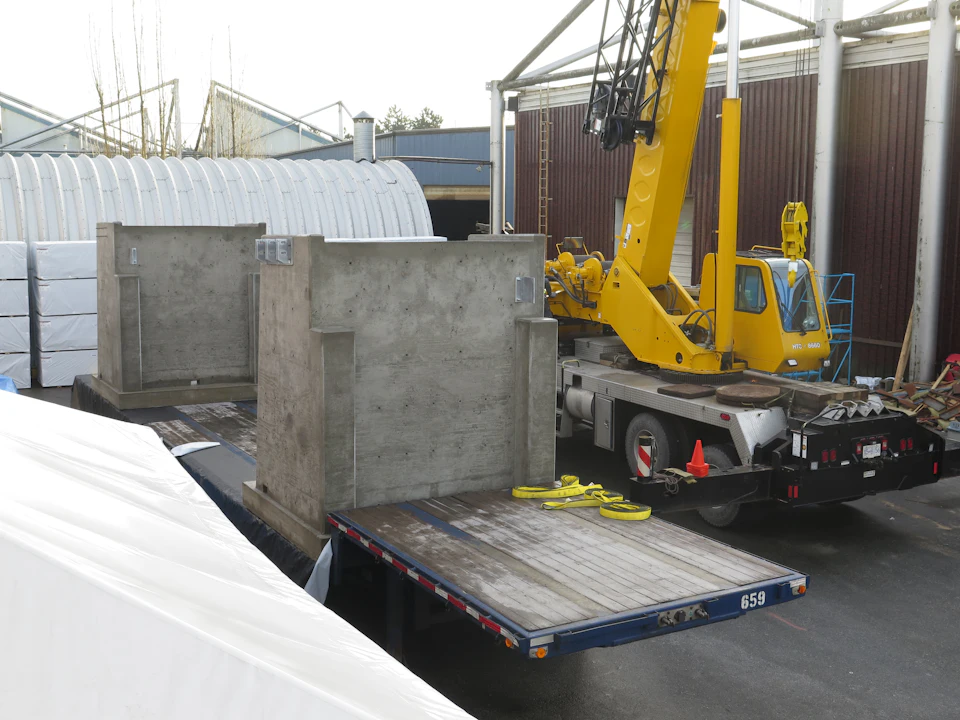 Concrete bridge abutments beside a crane