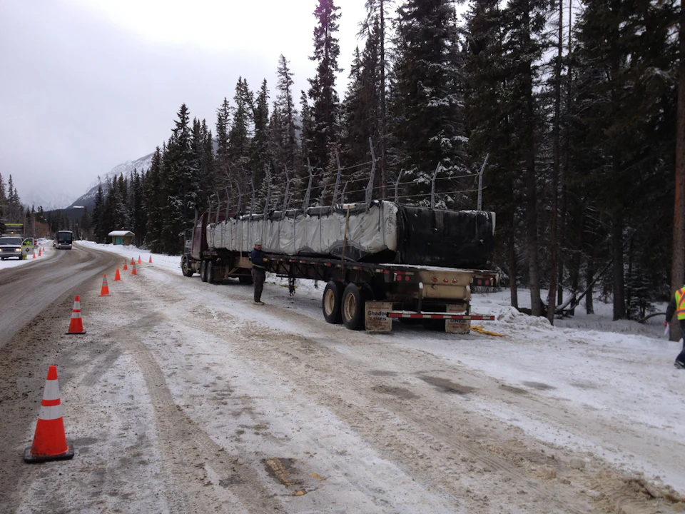 Bridge components transported along a snowy road