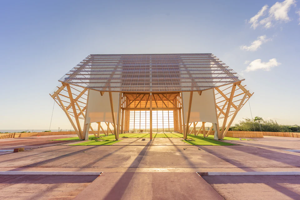 Open timber pavilion structure on a paved site