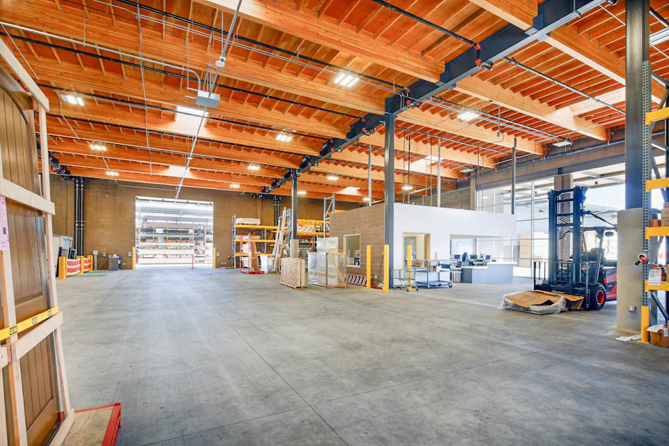 Open warehouse interior beneath a wood roof at Ganahl Lumber