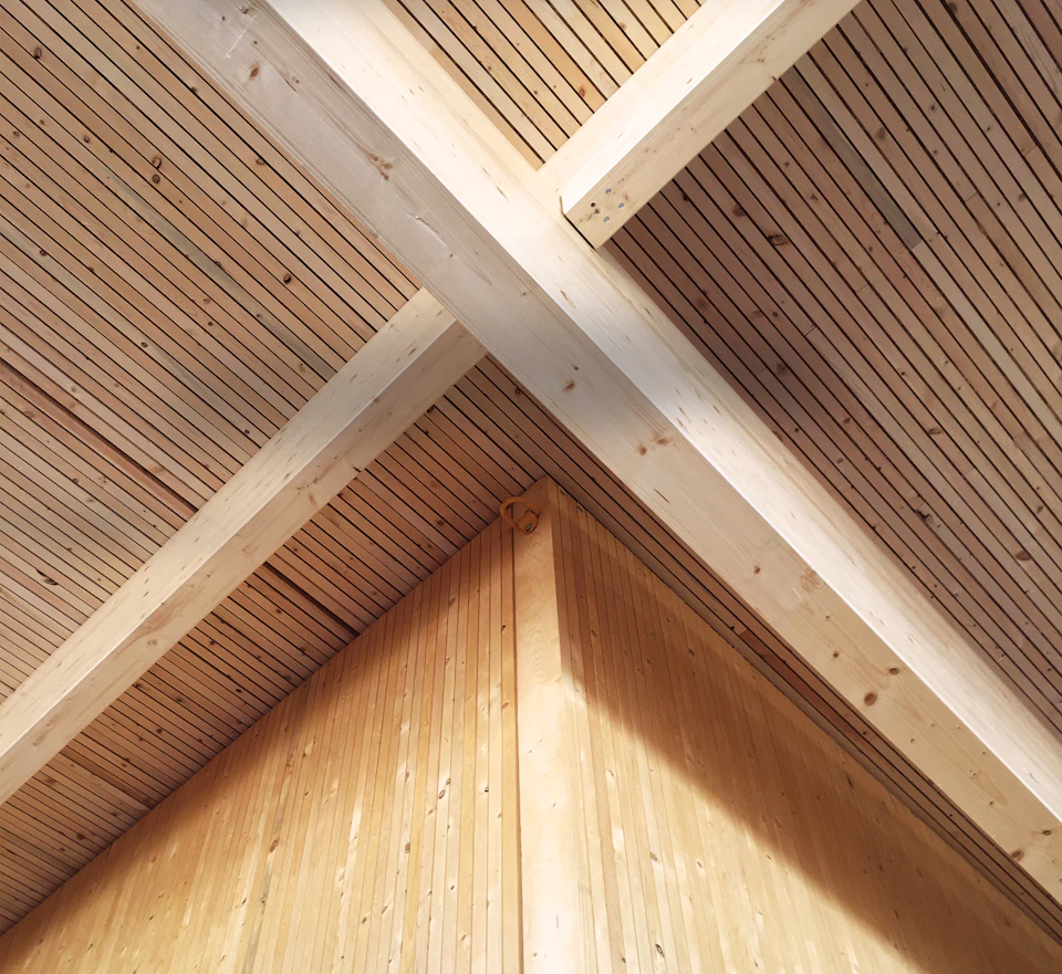 Crossing wood beams beneath the ceiling at StructureCraft Headquarters