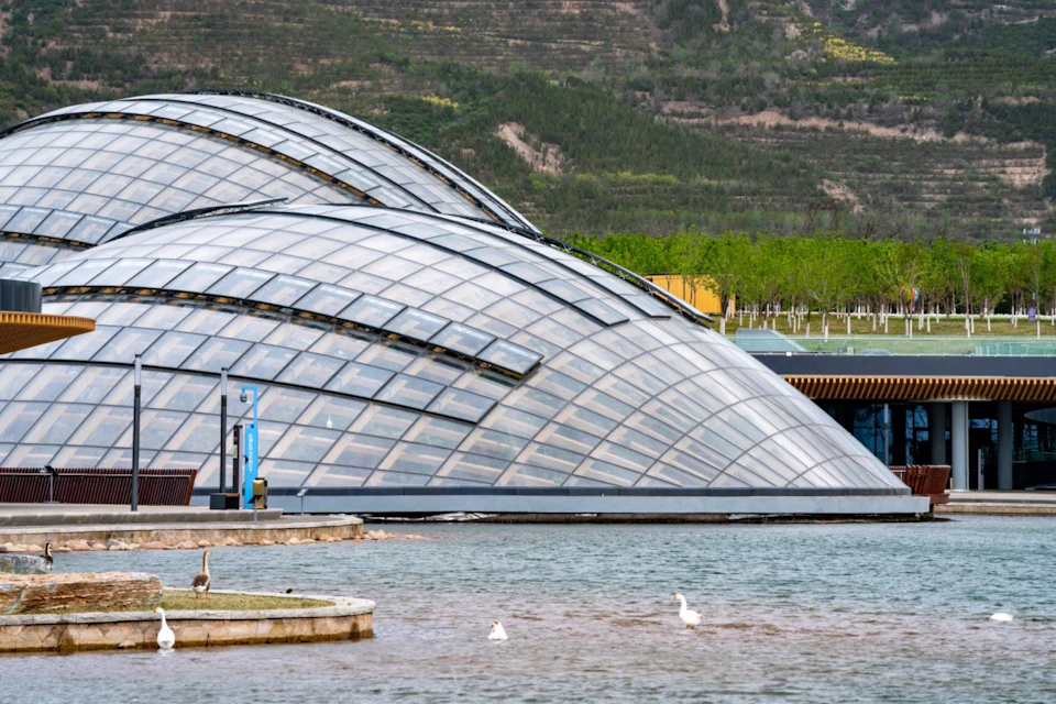 Glazed Taiyuan Botanical Garden domes beside water