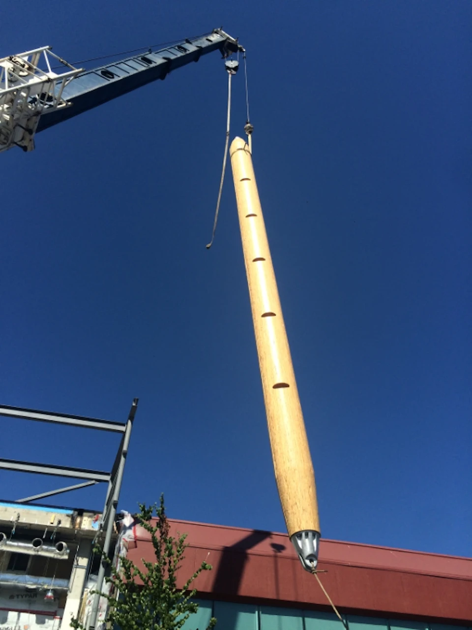 Tapered wood column being lifted at Central City