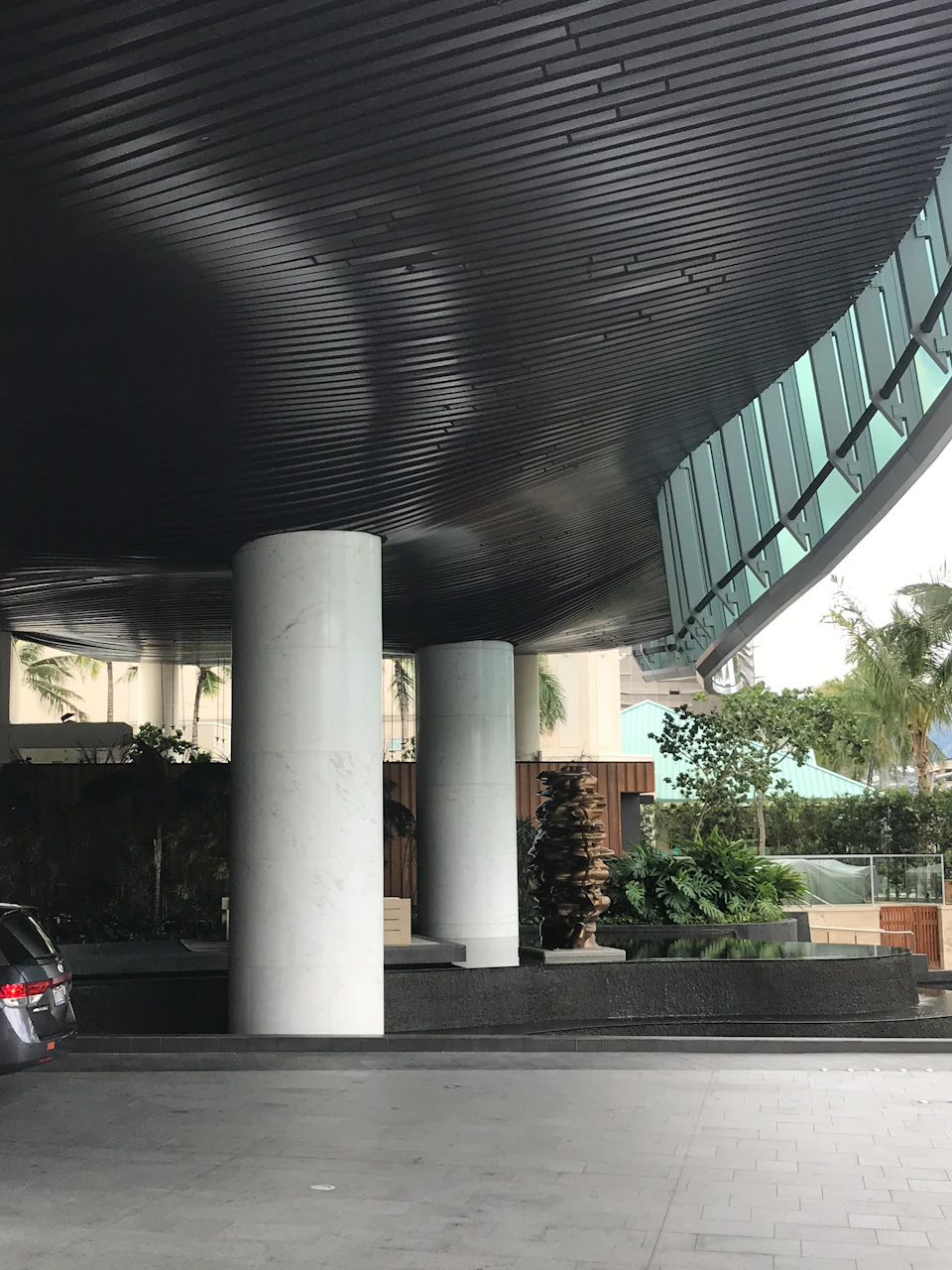Undulating timber soffit above round columns at Waiea Tower