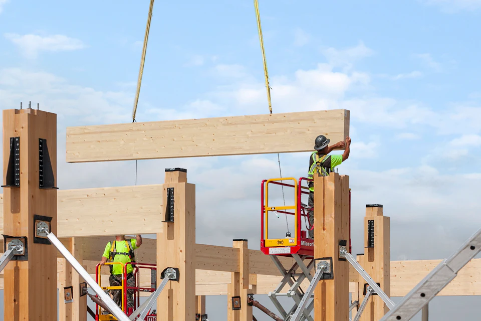 Wood beam suspended during construction at T3 FAT Village