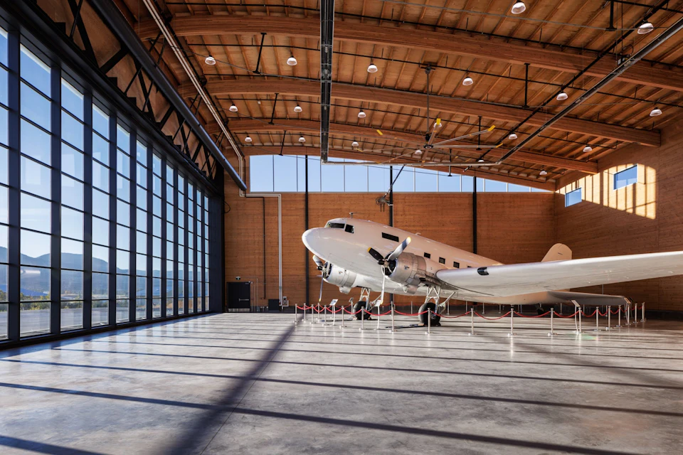 Hangar interior with wood roof and spiral stair at KF Aerospace Centre