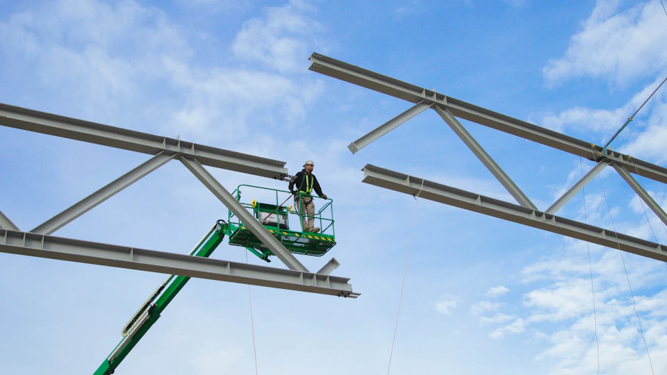 Steel roof trusses being installed at KF Aerospace Centre