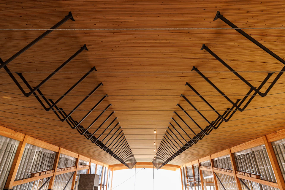 Wood ceiling with black hanger rods inside KF Aerospace Centre