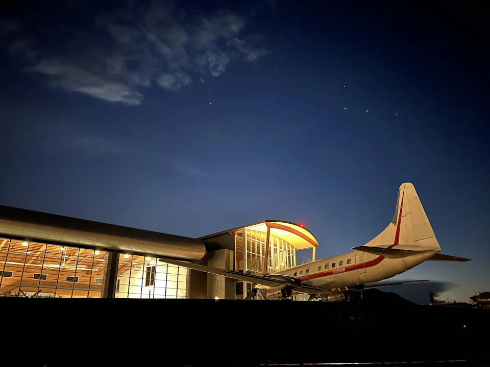 Aircraft outside KF Aerospace Centre for Excellence at night