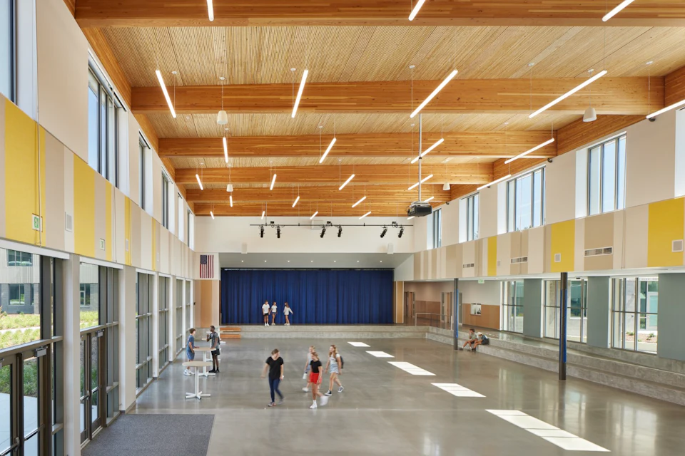 Multipurpose hall beneath a wood ceiling at Kellogg Middle School