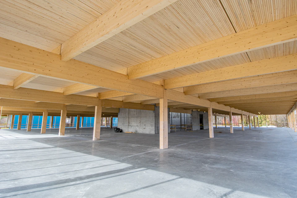 Open floor beneath wood beams at Nashville Warehouse Company Office
