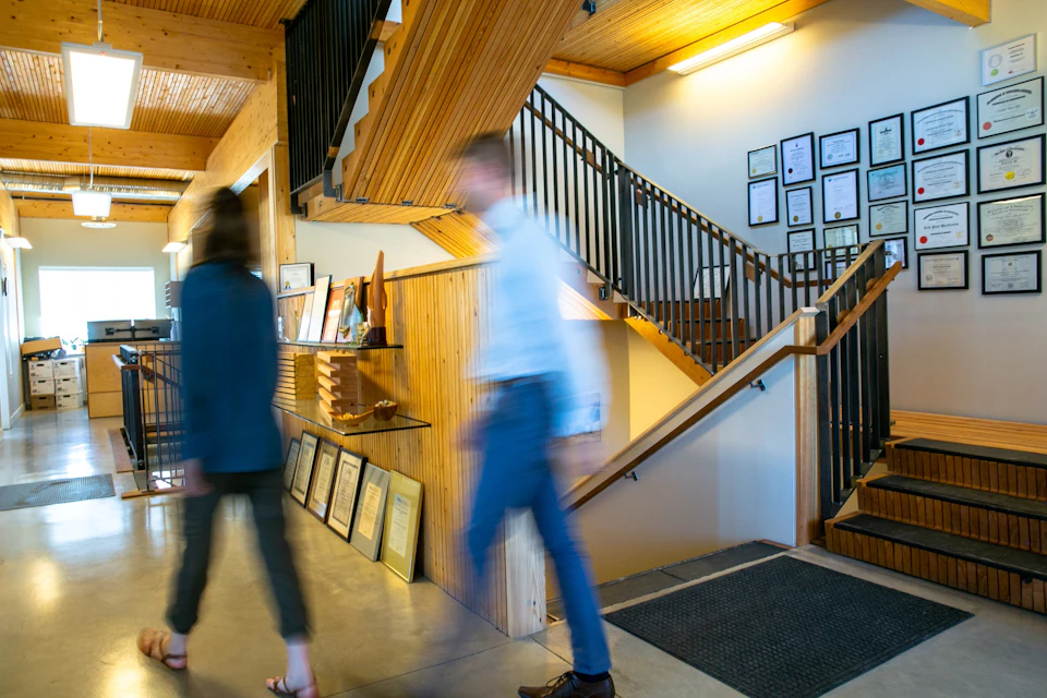 People walking through the StructureCraft Headquarters lobby
