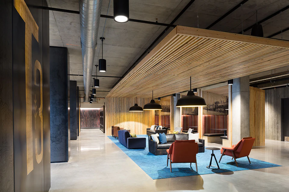 Lobby lounge beneath a wood ceiling at T3 Minneapolis