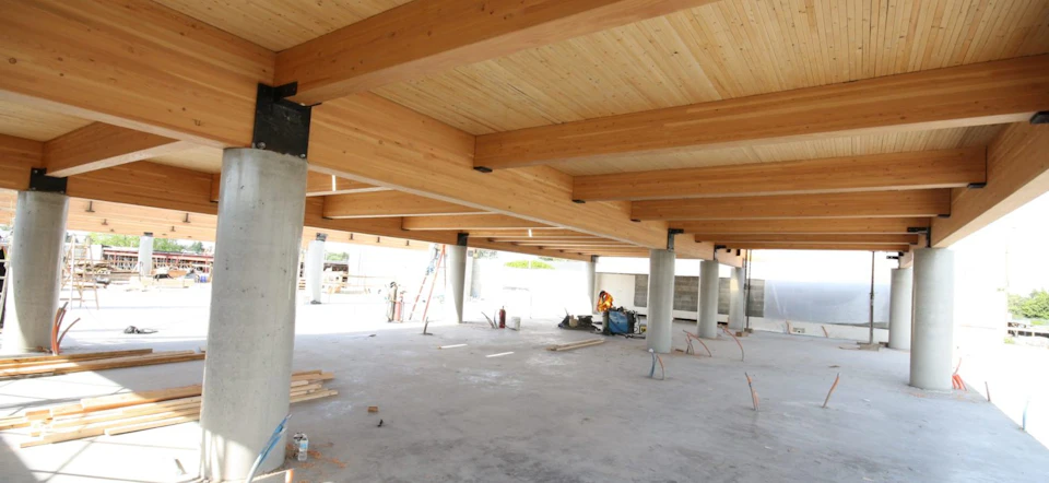 Wood roof under construction above concrete columns at Trail Appliances Headquarters