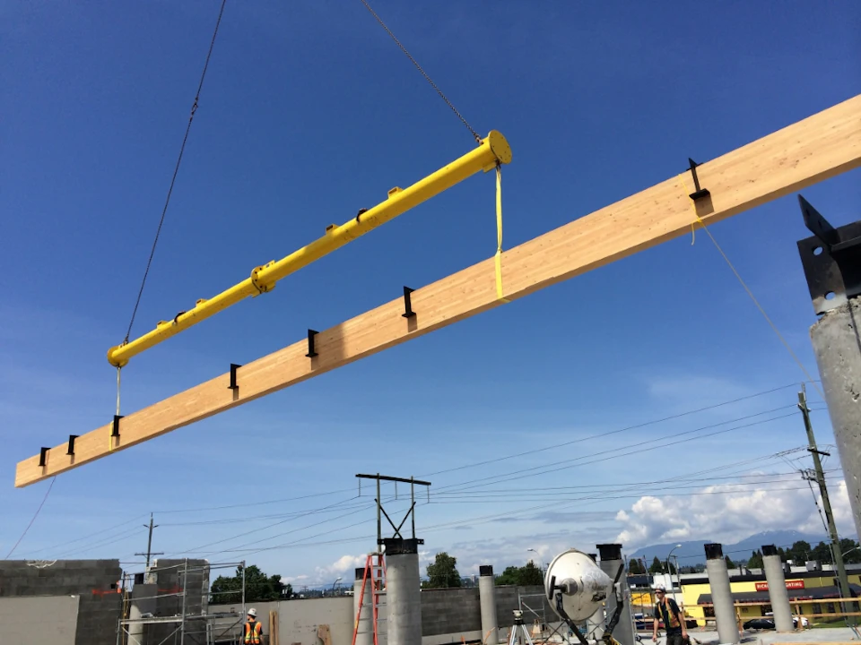 Long wood beam suspended during construction at Trail Appliances Headquarters