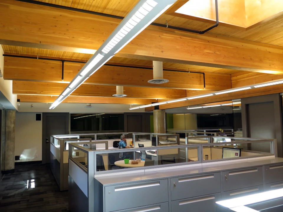 Office workspace beneath a wood ceiling at Trail Appliances Headquarters