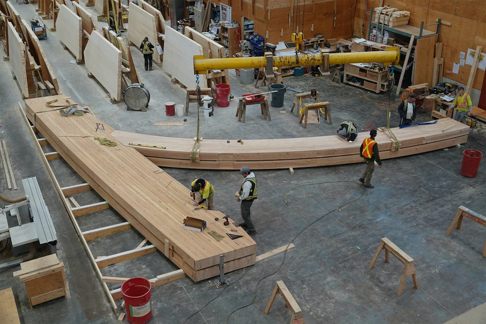 Curved arena beam assembly in the fabrication shop